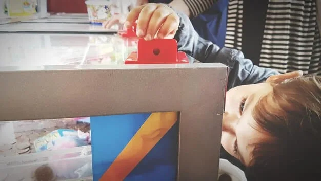 Detailed shot of a booth exhibiting a new line of educational STEM toys, featuring hands-on demonstrations and interactive displays. Children and their parents are shown engaging with the toys, and the booth is staffed by enthusiastic representatives explaining the toys' features and benefits.