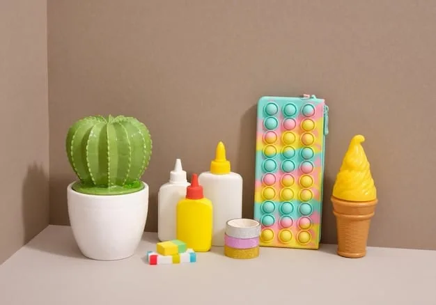 A collection of various sensory toys, including a bubble pop fidget toy, a textured teether, and a set of colorful stacking rings, displayed on a wooden table.