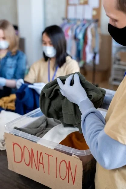 A close-up shot of a volunteer carefully sorting through donated toys, ensuring they are clean and in good condition before being distributed to children in need.