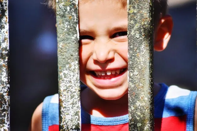 A split image showing, on one side, a happy child playing with a certified safe toy, and on the other side, a concerned parent holding a broken, potentially dangerous toy with small parts scattered around.