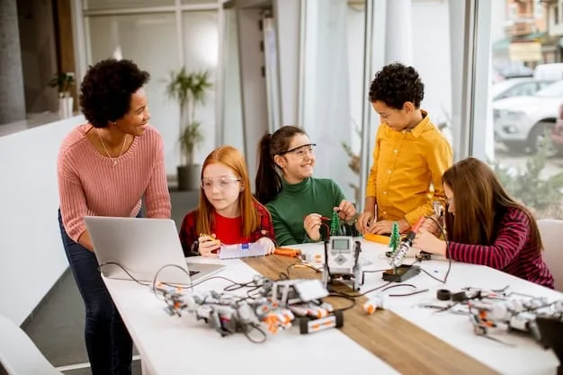 A group of children are gathered around a table in a robotics workshop, working together on building a robot. They are using laptops and tools, and the atmosphere is collaborative and engaging.