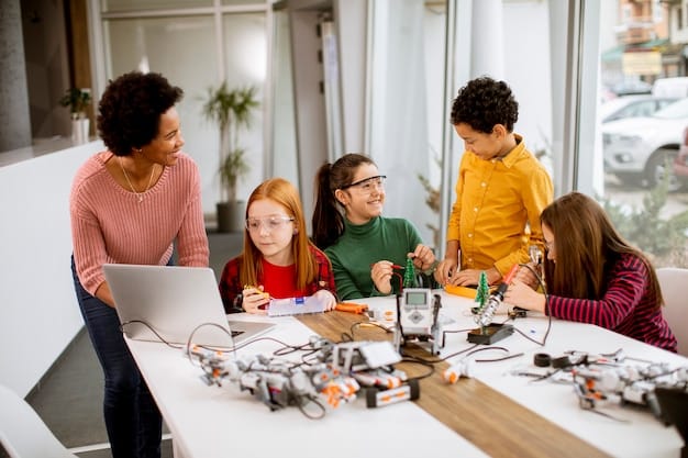 A group of children are gathered around a table in a robotics workshop, working together on building a robot. They are using laptops and tools, and the atmosphere is collaborative and engaging.
