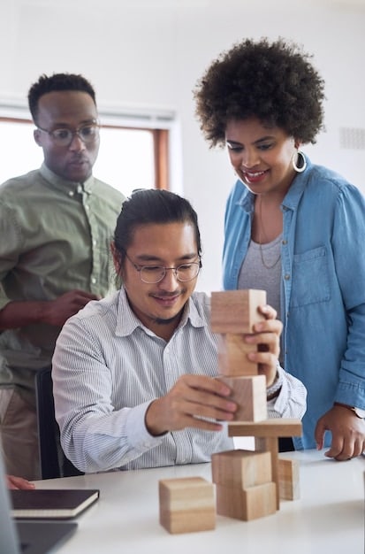 a medium shot of a diverse group of workers happily engaged in assembling toys in a well-lit, clean, and organized factory. The workers are smiling and appear content, showcasing a positive and ethical work environment.