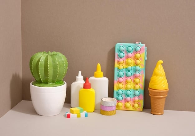 A collection of various sensory toys, including a bubble pop fidget toy, a textured teether, and a set of colorful stacking rings, displayed on a wooden table.