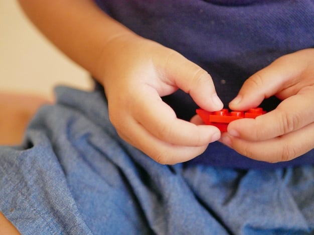 A close-up shot of a child's hands carefully assembling a complex interlocking toy that seems to have robotic components, with other toy parts scattered around them. The child's face is partially visible, showing intense concentration.