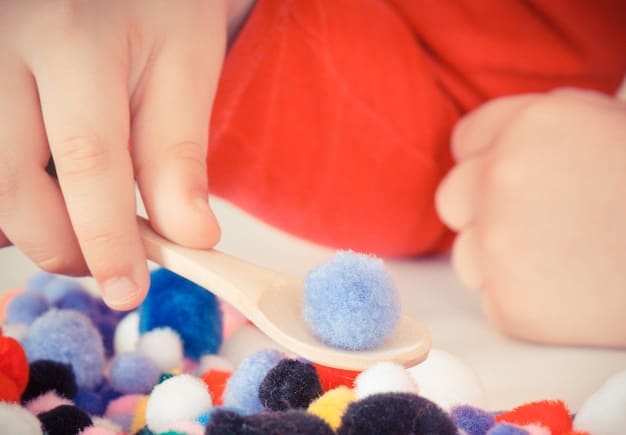 A sensory bin filled with colorful water beads, small toy animals, and scoops. A child's hands are immersed in the bin, exploring the textures and manipulating the objects.