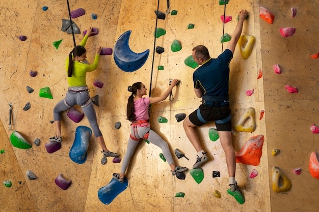 A group of children engaged in a rock climbing activity at an indoor climbing gym, with colorful climbing holds and safety harnesses, showcasing teamwork and physical challenge.