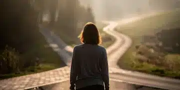 Person contemplating paths at a crossroads, symbolizing the journey of finding purpose