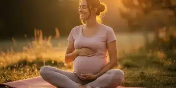Pregnant woman practicing gentle prenatal yoga outdoors at sunrise, embodying peace and connection.